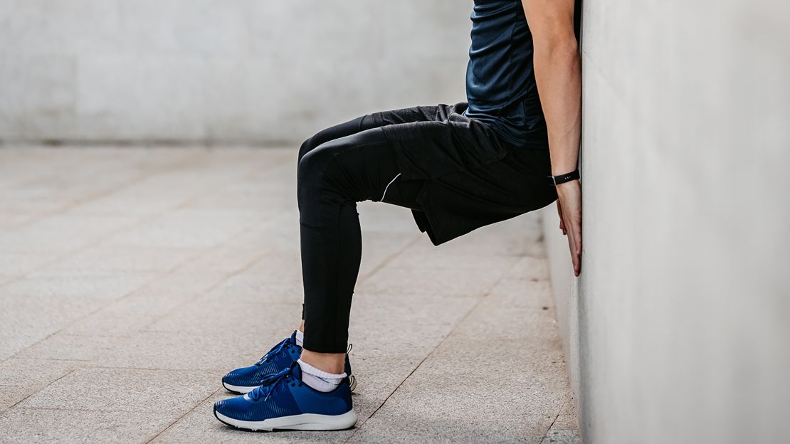 Performing wall sits engages and strengthens lower body muscles.