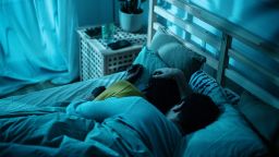 Couple cuddling together in the bed sleeping at night