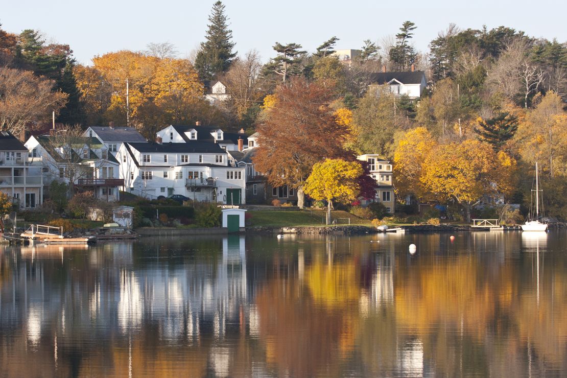 Autumn trees are reflected in the waters of the Northwest Arm in Halifax, Nova Scotia. Cruise Critic says there are good fall deals on cruises to Canada.