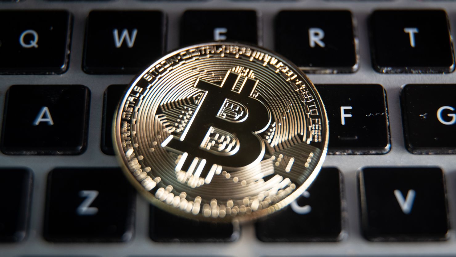 In this photo illustration a novelty Bitcoin token is placed on a computer keyboard, on March 13, 2022 in Bristol, England.