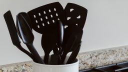 Close-up view of cooking utensils in container on kitchen counter