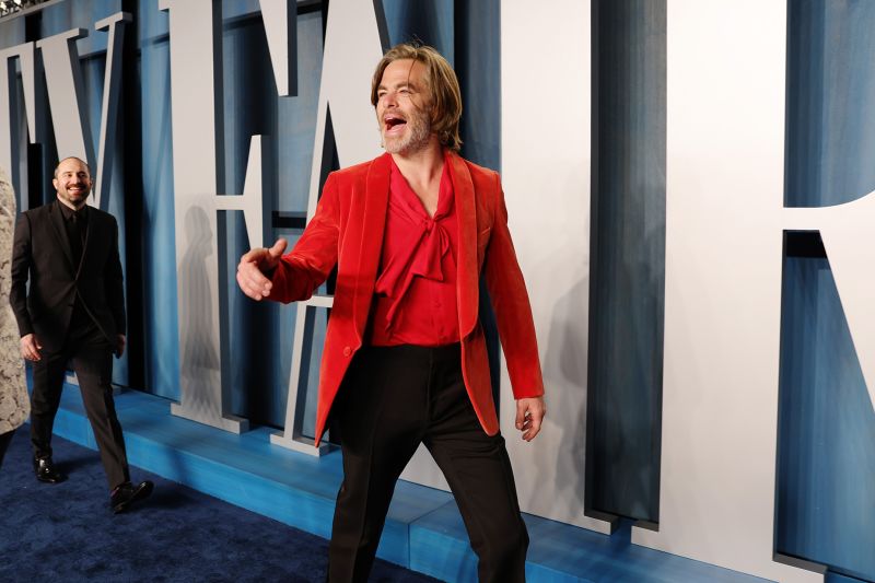 For the Vanity Fair Oscar's after party on March 27, 2022, Chris Pine wore a rich red velvet smoking jacket over a shirt with a pussybow-style neckline.