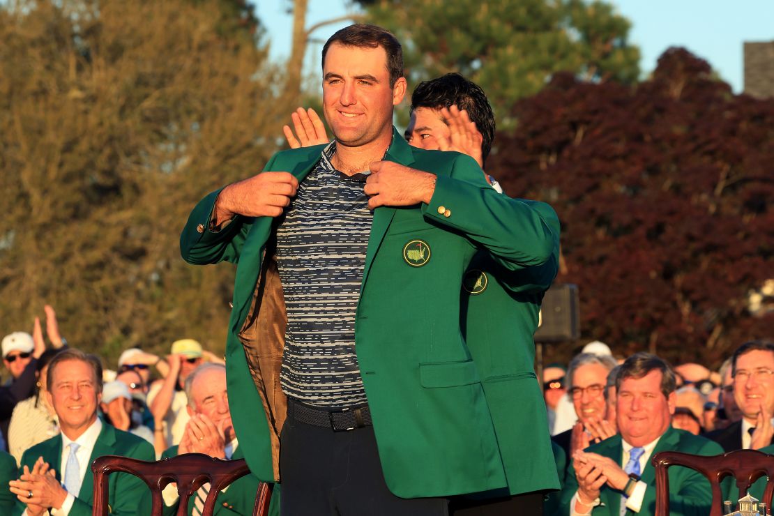 Scheffler is awarded the green jacket by 2021 Masters champion Hideki Matsuyama after he won the Masters at Augusta National Golf Club in 2022.