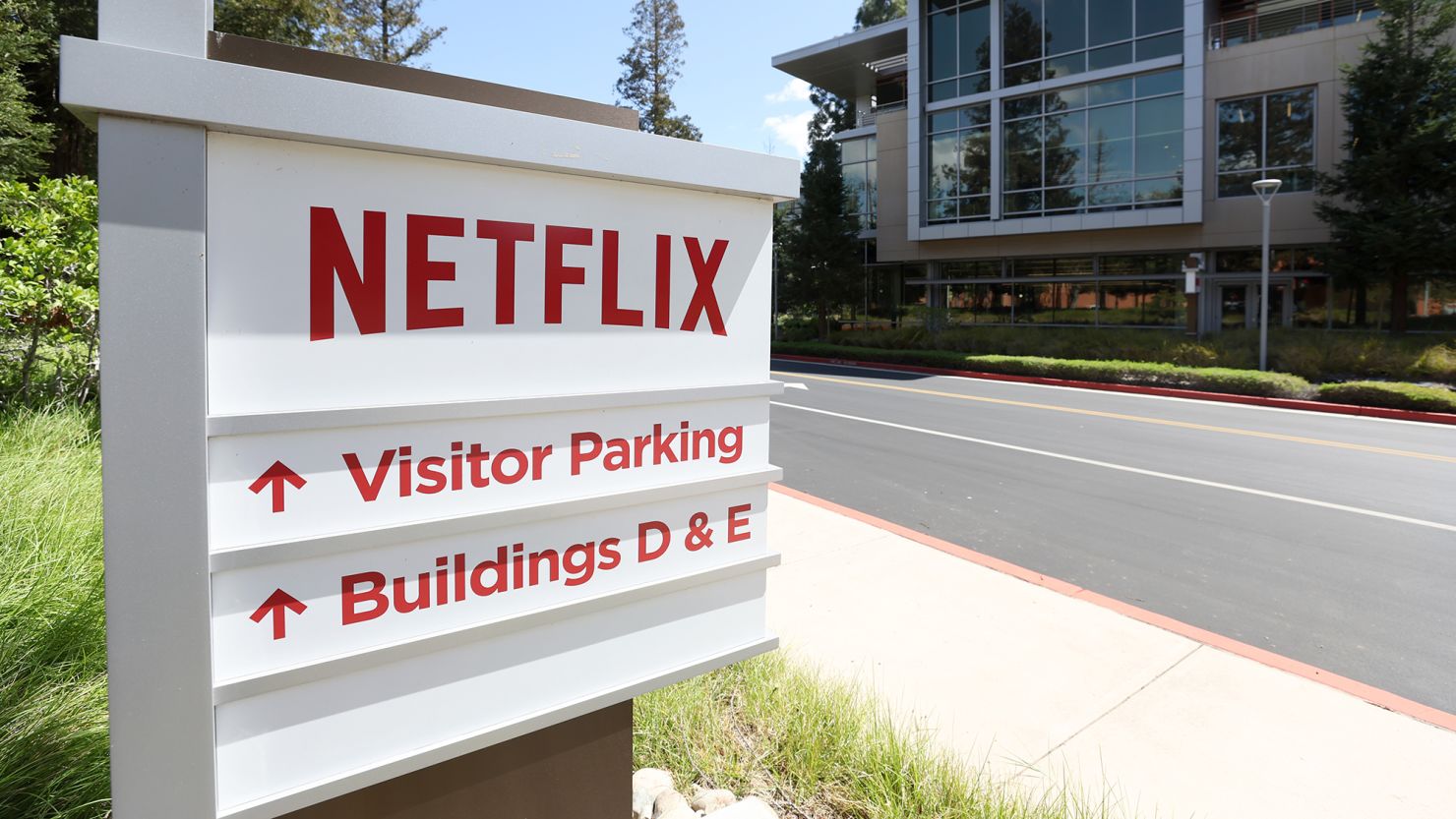 A sign is posted in front of Netflix headquarters on April 20, 2022, in Los Gatos, California. The streaming giant has shown little-to-no interest in investing in either live-news or pre-taped programming.