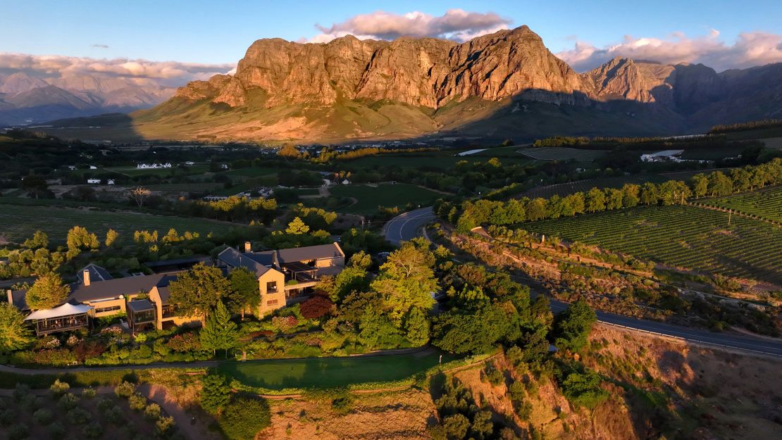 This equinox means fall is coming in the Southern Hemisphere. This is an evening aerial view of the Tokara Wine Estate below the Drakenstein Mountains in Stellenbosch, South Africa.