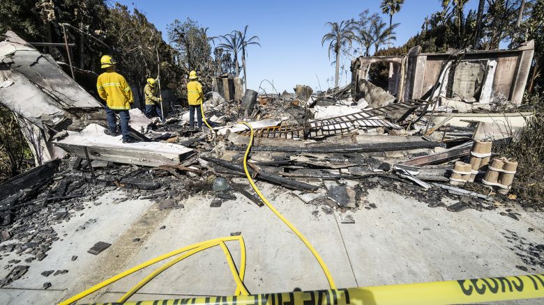 A firefighter puts out hot spots at a house on Coronado Pointe in Laguna Niguel, CA on Thursday, May 12, 2022. The Coastal fire destroyed 20 homes after starting on Wednesday, May 11, in Aliso Woods Canyon.