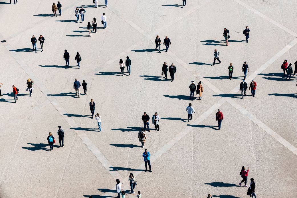 Aerial view of people walking on a city square.