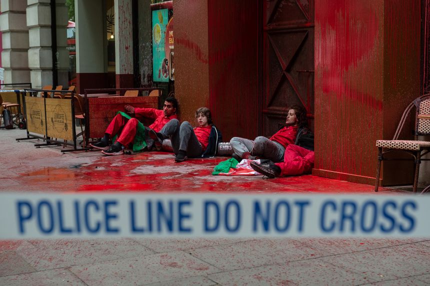 Palestine Action activists let off smoke grenades and spray red paint outside the London offices of Elbit Systems in May 2022.