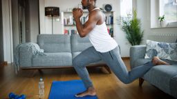 Strong athletic fit man exercising at his home
