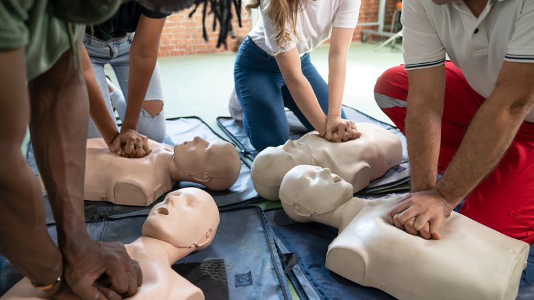 Small group of people first aid CPR training class.