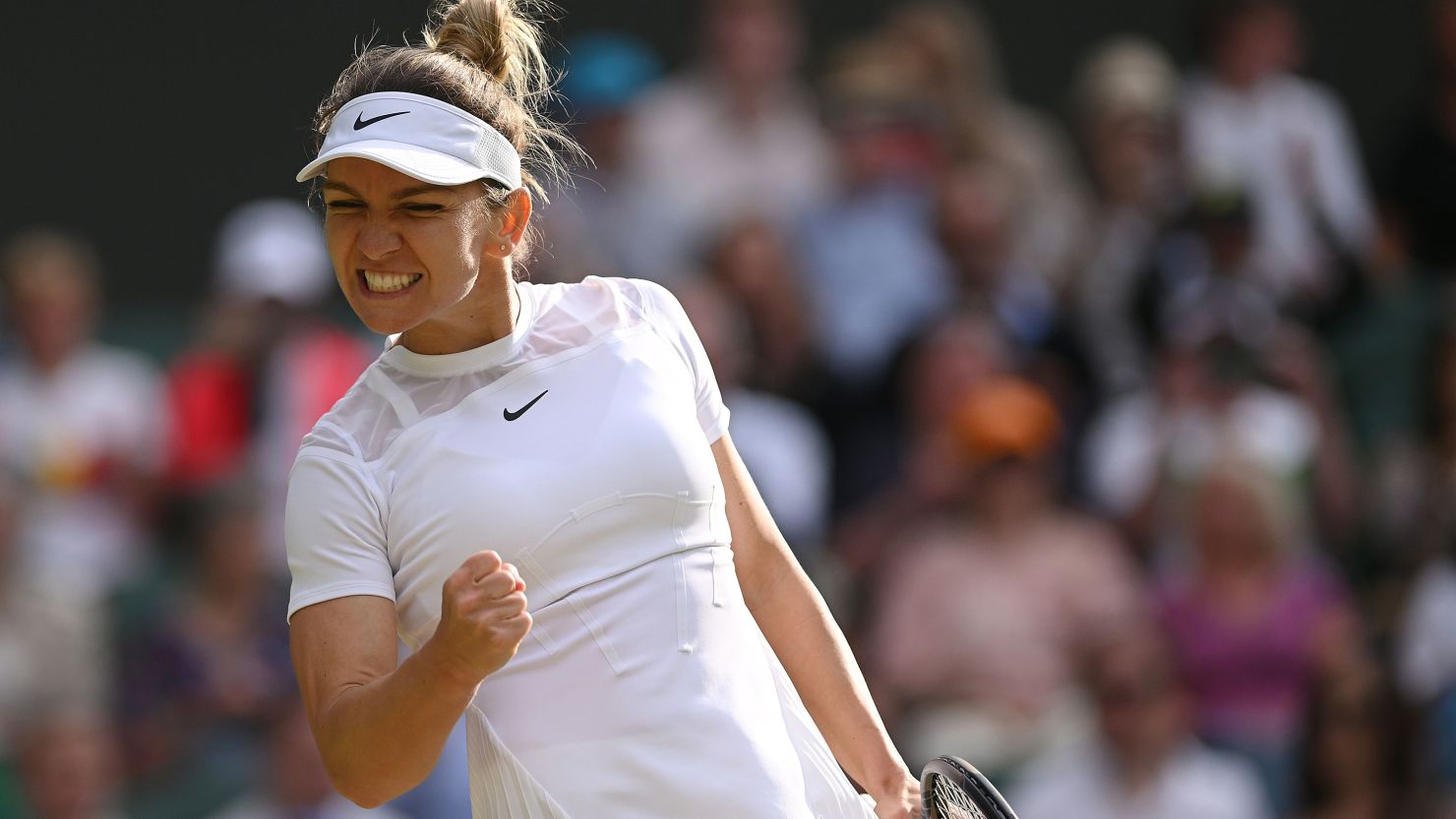 Simona Halep celebrates winning a match at Wimbledon in 2022.
