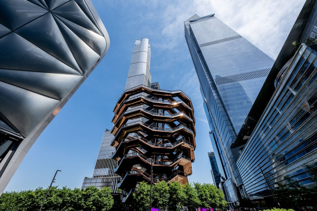 The Vessel in Manhattan's Hudson Yards neighborhood sits in the middle of several steel and glass skyscrapers and a train yard.