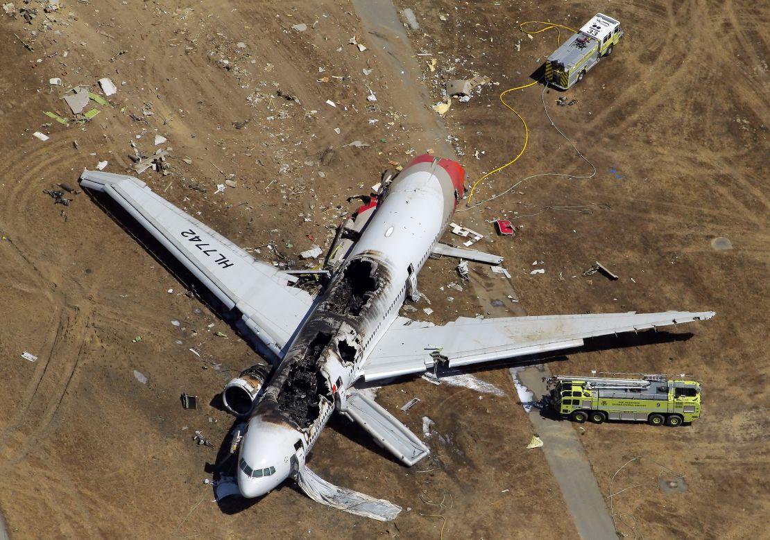 The destroyed fuselage of Asiana Airlines Flight 214 is visible on the runway at San Francisco International Airport after it crashed on landing and burned on Saturday, July 6, 2013. (Photo By Carlos Avila Gonzalez/The San Francisco Chronicle via Getty Images)