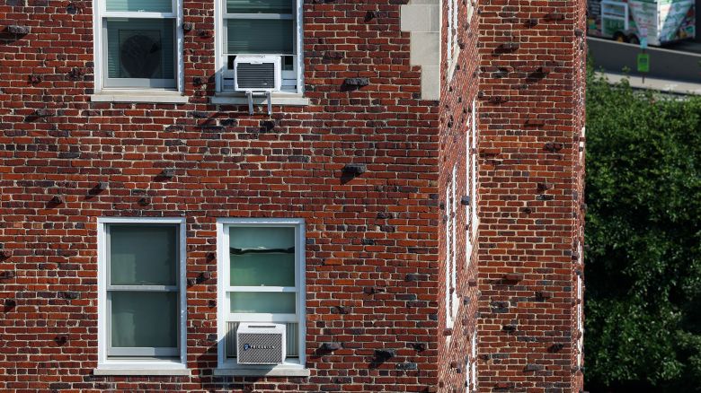 WASHINGTON, DC - JULY 20: Air conditioner units sit in windows of an apartment building on July 20, 2022 in Washington, DC. Along with other cities across the U.S. temperatures in DC are expected to rise over the next few days and reach 100 degrees by this weekend. (Photo by Anna Moneymaker/Getty Images)