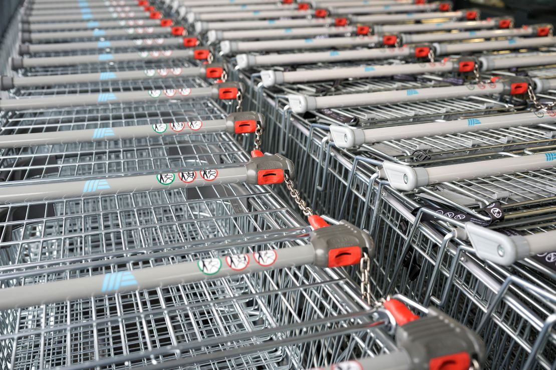 Shopping carts at the Aldi store on July 22, 2022 in Tarleton, United Kingdom. The carts are released by inserting a coin that is later refunded.