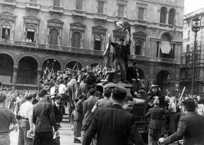 Antifascist protesters arrive on a truck at a crowded piazza in Milan, Italy, in July 1943.