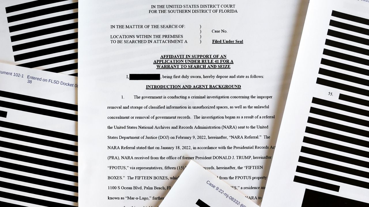 In this photo illustration, pages are viewed from the government's released version of the TBI search warrant affidavit for former President Donald Trump's Mar-a-Lago estate on August 27, 2022, in California.