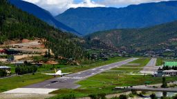 Paro, Bhutan: an Airbus A319 lands at Paro International Airport, the only international airport in Bhutan, located in a deep valley on the bank of the river Paro Chhu, with surrounding peaks as high as 5,500m (18,000 ft), it is considered one of the world's most challenging airports, flights operate only in visual meteorological conditions (VMC), an aviation flight category in which visual flight rules (VFR) flight is permitted. The airport has a single 2,265 m (7,431 ft) asphalt runway.