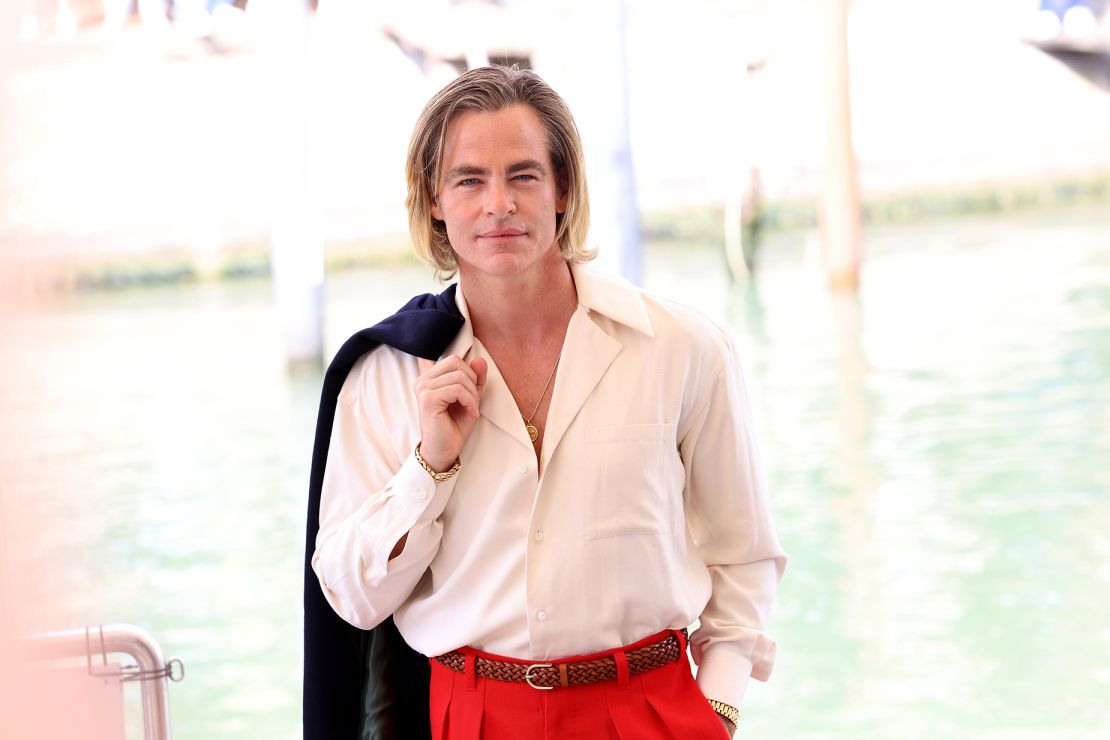 Pictured here in slouchy red, white and blue suiting, Pine attends the Venice International Film Festival on September 05, 2022.