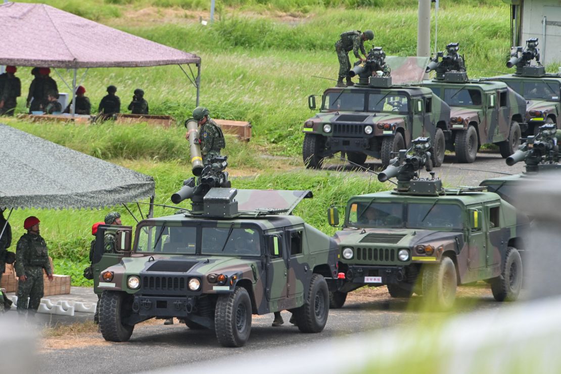 Military vehicles queue to launch US-made TOW A2 missiles during a live firing exercise in Pingtung county, southern Taiwan, on July 3, 2023.