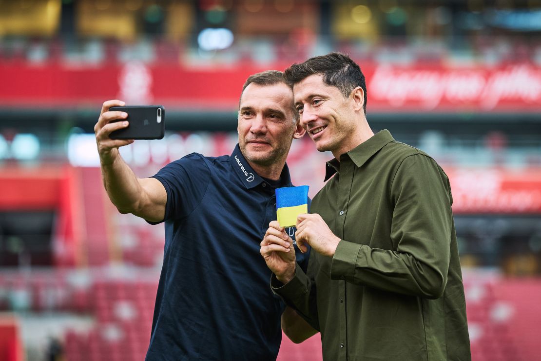 WARSAW, POLAND - SEPTEMBER 20: Poland captain Robert Lewandowski receives a Ukraine armband from Laureus Ambassador Andriy Shevchenko and pledges to carry it to FIFA World Cup 2022 Qatar at PGE Narodowy Stadium on September 20, 2022 in Warsaw, Poland. (Photo by Joosep Martinson/Getty Images for Laureus)