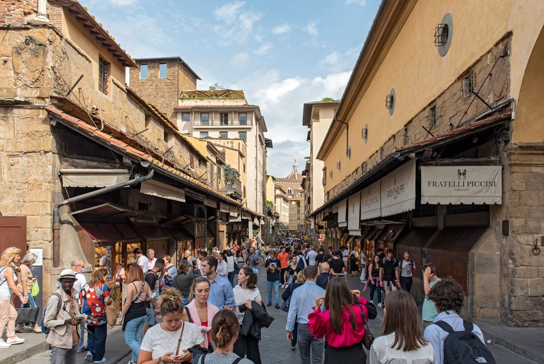 Tourists flood one of Florence's popular attractions, the Ponte Vecchio bridge.