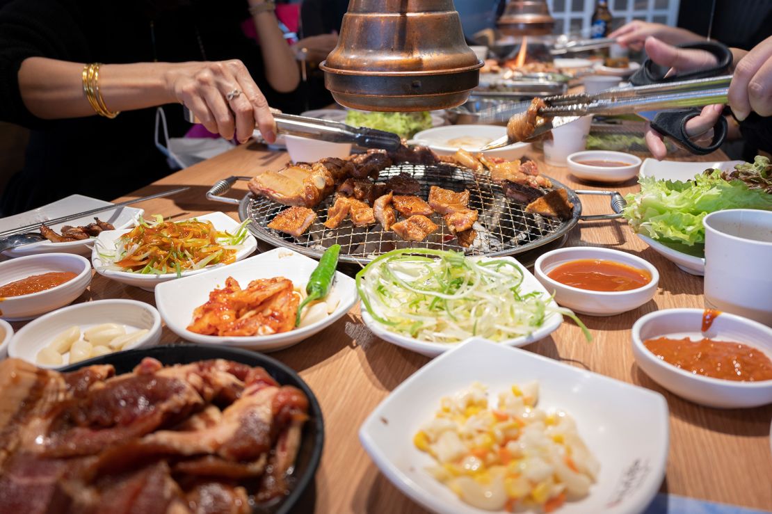 Korean BBQ usually features a grill that's surrounded by an assortment of banchan (side dishes).