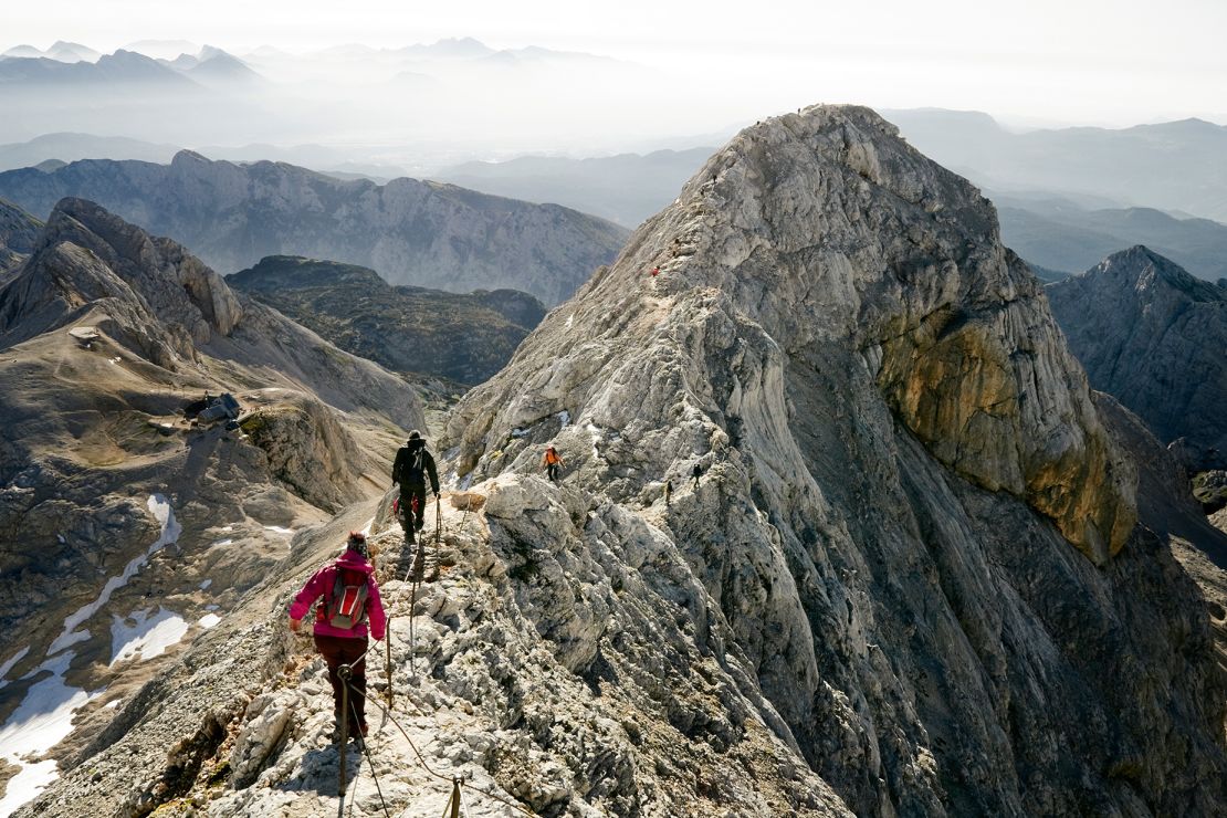 Mountaineers climbing ridge on Triglav mountain, Slovenia.