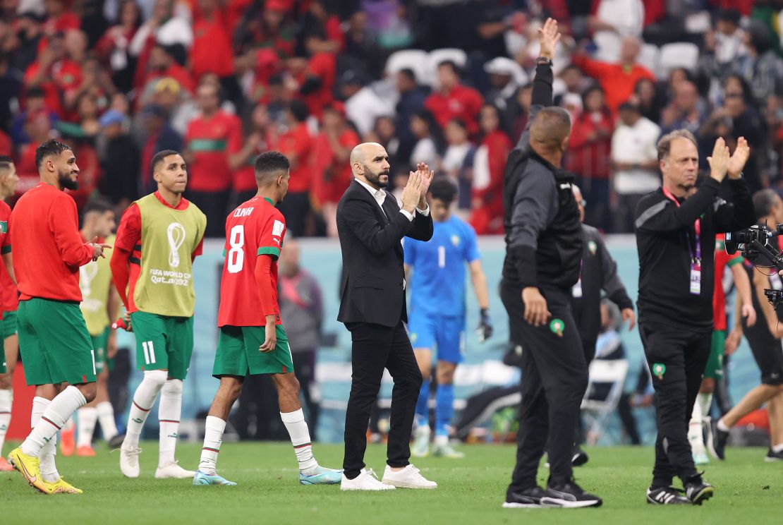 Regragui, center, applauds supporters after the team's 0-2 defeat to France in the semifinals of the 2022 FIFA World Cup in Qatar on December 14, 2022.