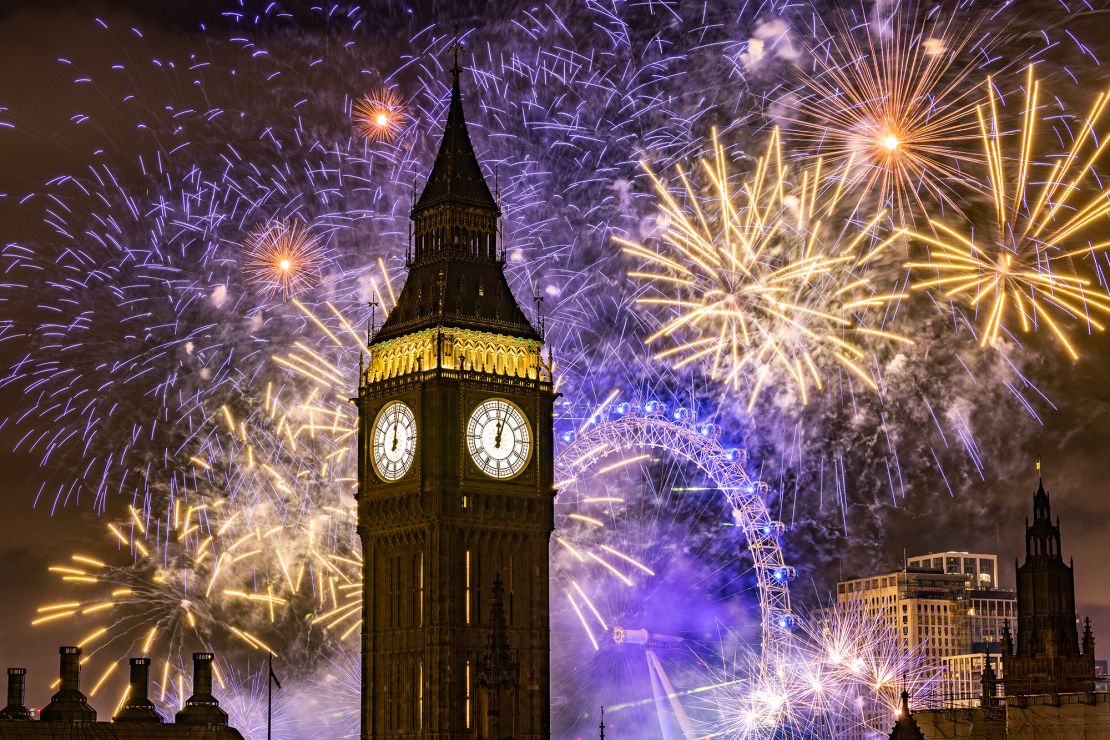 Fireworks light up the London skyline over Big Ben and the London Eye just after midnight on January 1, 2023, in London.