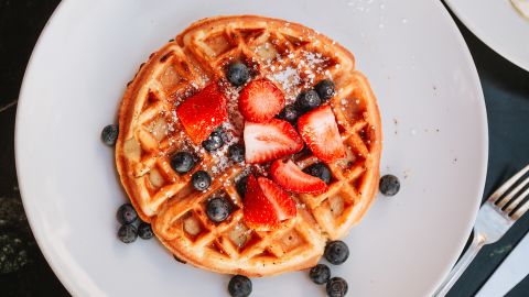 Waffles with strawberries and blueberries, directly above close-up view