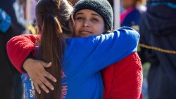 EL PASO, TEXAS - JANUARY 07: Honduran immigrant Jenny gets a hug from a good samaritan while outside a migrant shelter on January 07, 2023 in El Paso, Texas. President Joe Biden is scheduled to visit El Paso Sunday, his first visit to the border since he became president two years before. U.S. Border authorities took into custody some 2.5 million migrants in 2022, the highest number on record. (Photo by John Moore/Getty Images)