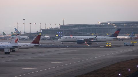 SHANGHAI, CHINA - JANUARY 08: Delta Air Lines DL283 arrives at Shanghai Pudong International Airport on January 8, 2023 in Shanghai, China. Mandatory?quarantine?requirements and on-arrival polymerase chain reaction (PCR) tests are not required for inbound travelers in Shanghai as China further optimizes the international exchanges. (Photo by Yin Liqin/China News Service/VCG via Getty Images)