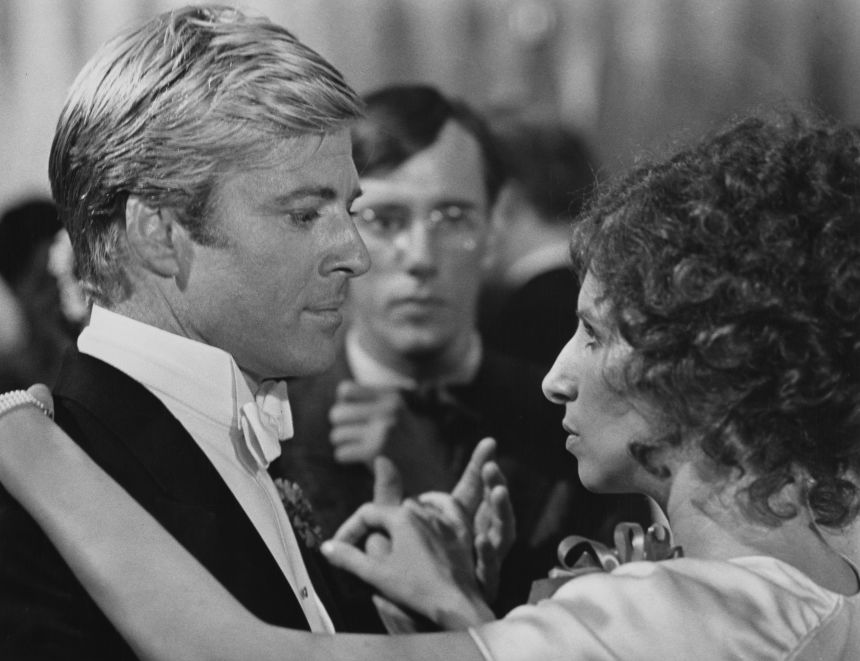 Robert Redford and Barbra Streisand dancing in a publicity still for the romantic drama "The Way We Were" from 1973.