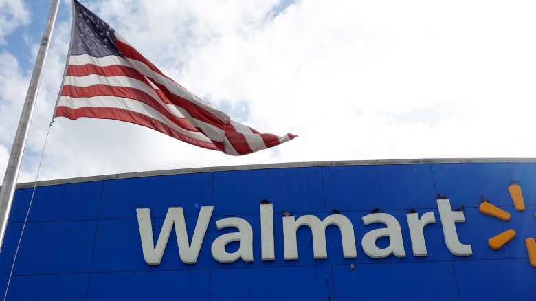 MIAMI, FLORIDA - JANUARY 24: An American flag flies outside of a Walmart store on January 24, 2023 in Miami, Florida. Walmart announced that it is raising its minimum wage for store employees in early March, store employees will make between $14 and $19 an hour. They currently earn between $12 and $18 an hour. (Photo by Joe Raedle/Getty Images)