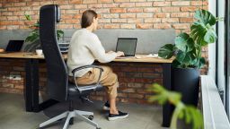 Unrecognisable businesswoman working on laptop in office