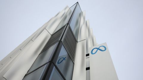 A security guard stands next to a sign at Meta headquarters on February 02, 2023 in Menlo Park, California.