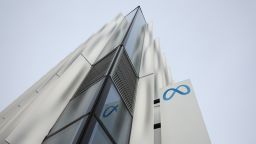 A security guard stands next to a sign at Meta headquarters on February 02, 2023 in Menlo Park, California.