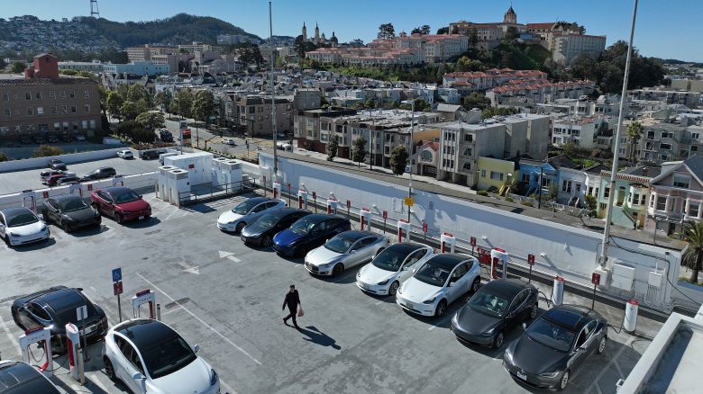 In an aerial view, Tesla cars recharge at a Tesla Supercharger station on February 15, 2023 in San Francisco, California.