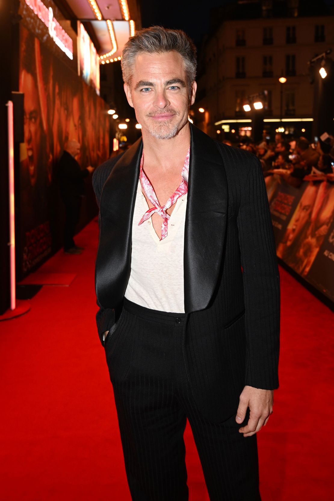 At a "Dungeons & Dragons" movie premiere in Paris on March 22, 2023, Pine paired a tuxedo jacket with a deep V-neck tee and silk scarf.