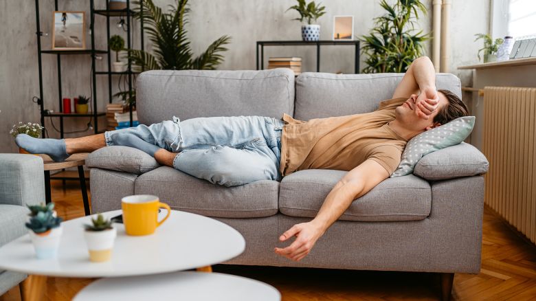 Handsome young man sleeping on the sofa at home.