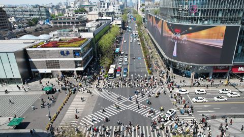 Aerial view of pedestrians walking at a hectic zebra crossing junction in the shape of 'X' on April 9, 2023 in Hangzhou, Zhejiang Province of China.