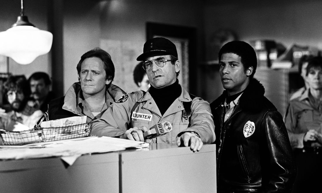 Sikking (center) as Howard Hunter in 