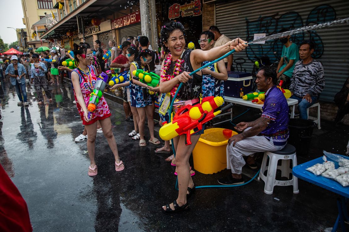 Festival goers take part in a water fight on Khao San Road on April 13, 2023.