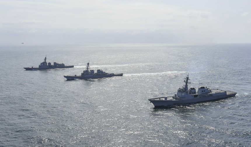 South Korean Navy's destroyer Yulgok Yi I (R), US Navy's USS Benfold (C) and Japan Maritime Self-Defense Force's JS Atago (L) sail in formation during a joint naval exercise in 2023