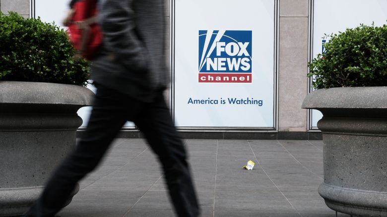 People walk by the News Corporation headquarters, home to Fox News, on April 18, 2023 in New York City.