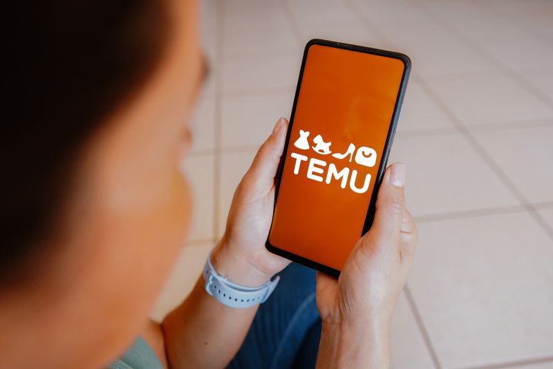 Temu's logo is displayed on a smartphone screen