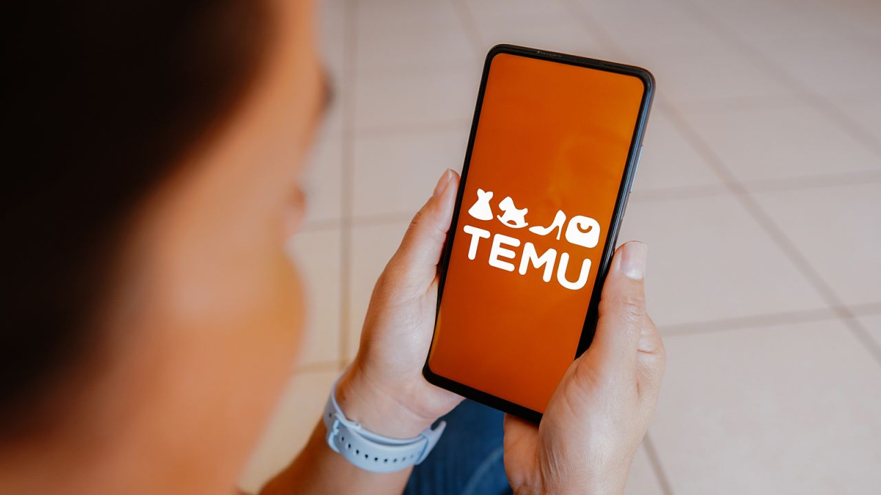 Temu's logo is displayed on a smartphone screen