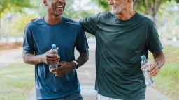 Senior friends walking in public park