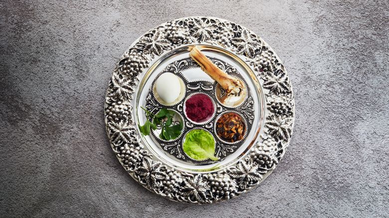 Passover Seder plate with traditional food on grunge background.